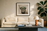 Harvest Cow Sage Square by Yvette St. Amant. Displayed in a glass frame with matte in a clean modern living room. Available as an archival giclee rolled canvas, fine art paper, or poster print. SKU 93682a.