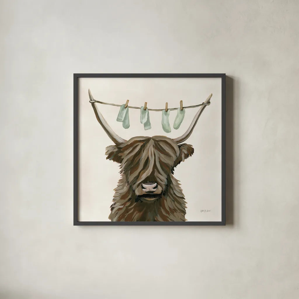 Highland Cow Clothesline by Yvette St. Amant. Shown in a sleek black glass frame for a contemporary gallery look. Available as an archival giclee rolled canvas, fine art paper, or poster print. SKU 89452a.