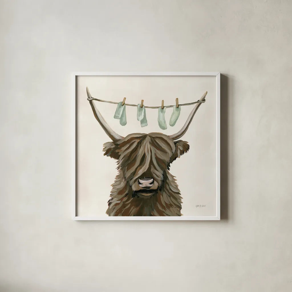Highland Cow Clothesline by Yvette St. Amant. Shown in a crisp white glass frame for a clean and minimalist style. Available as an archival giclee rolled canvas, fine art paper, or poster print. SKU 89452a.