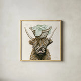 Highland Cow Laundry Basket by Yvette St. Amant. Shown in a natural wood glass frame for a timeless modern aesthetic. Available as an archival giclee rolled canvas, fine art paper, or poster print. SKU 89453a.