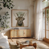 Highland Cow Laundry Basket by Yvette St. Amant. Shown in a natural wood frame in a cozy modern living room. Available as an archival giclee rolled canvas, fine art paper, or poster print. SKU 89453a.