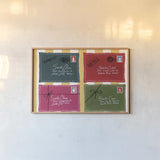 Holly Jolly Mail VII by Yvette St. Amant. shown as a paper print in a natural frame. Available as a archival giclee rolled canvas, fine art paper, or poster print. SKU 103290i.