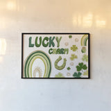Lucky Charm I by Yvette St. Amant. shown as a paper print in a black flame. Available as a archival giclee rolled canvas, fine art paper, or poster print. SKU 100557i.