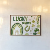 Lucky Charm I by Yvette St. Amant. shown as a paper print in a natural frame. Available as a archival giclee rolled canvas, fine art paper, or poster print. SKU 100557i.
