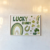 Lucky Charm I by Yvette St. Amant. shown as a paper print in a white frame. Available as a archival giclee rolled canvas, fine art paper, or poster print. SKU 100557i.