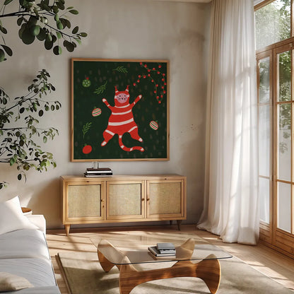 Mischief Kitty Christmas II by Yvette St. Amant. Shown in a natural wood frame in a cozy modern living room. Available as an archival giclee rolled canvas, fine art paper, or poster print. SKU 97541a.