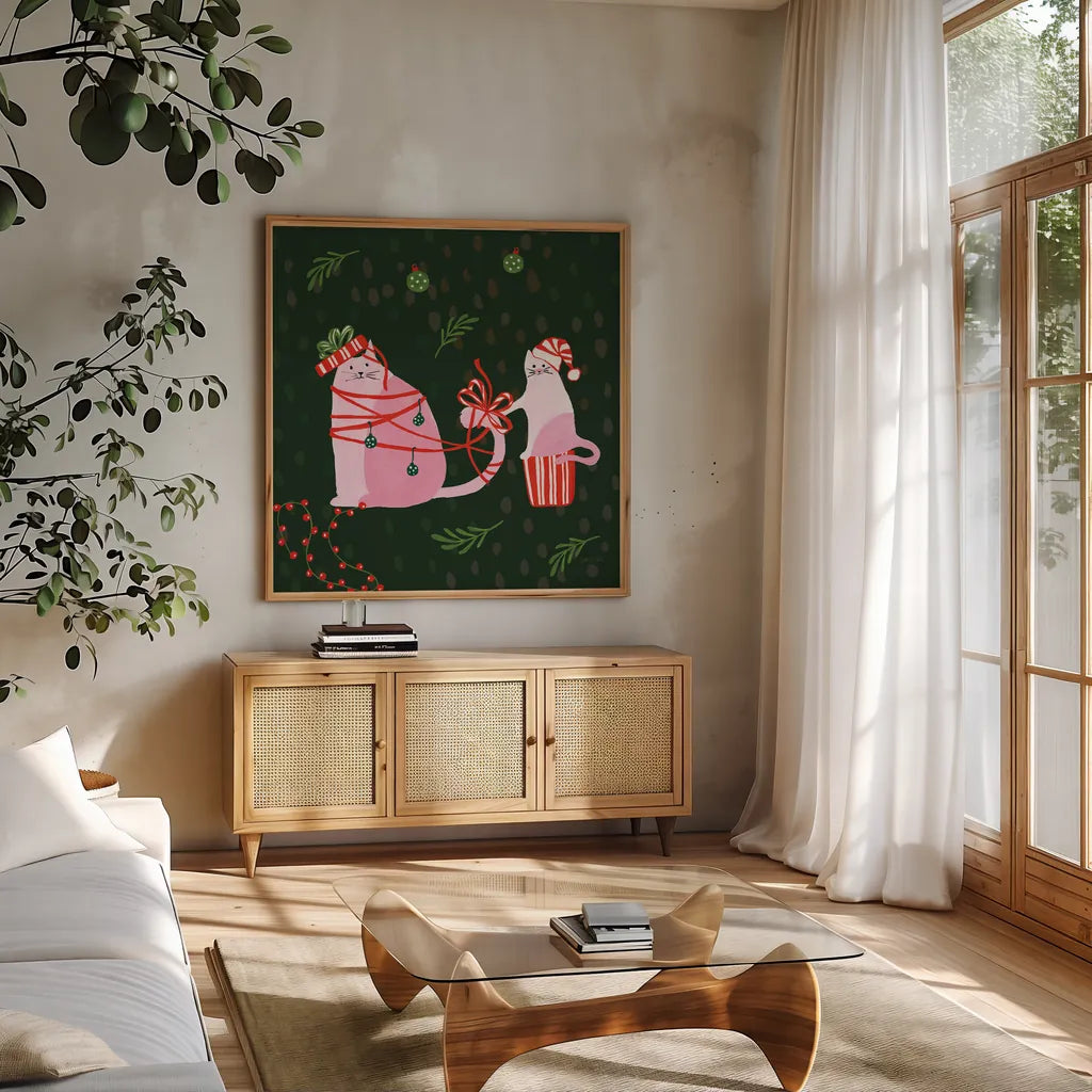 Mischief Kitty Christmas IV by Yvette St. Amant. Shown in a natural wood frame in a cozy modern living room. Available as an archival giclee rolled canvas, fine art paper, or poster print. SKU 97543a.