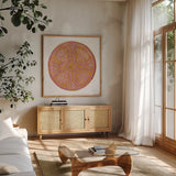 Mustard Mandala by Yvette St. Amant. Shown in a natural wood frame in a cozy modern living room. Available as an archival giclee rolled canvas, fine art paper, or poster print. SKU 88261a.