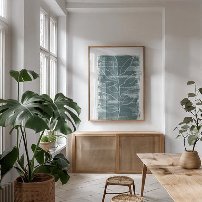 Simple Sprigs of Bay Leaf by Yvette St. Amant. shown as a print in a natural wood frame in a dining room. Available as a archival giclee rolled canvas, fine art paper, or poster print. SKU 93599h.