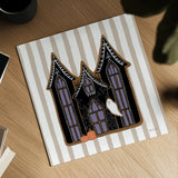 Spooky Gingerbread Manor I by Yvette St. Amant. Shown as a detailed flat fine art print, highlighting archival giclee quality. Available as an archival giclee rolled canvas, fine art paper, or poster print. SKU 101109a.