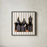 Spooky Gingerbread Manor II by Yvette St. Amant. Shown in a sleek black glass frame for a contemporary gallery look. Available as an archival giclee rolled canvas, fine art paper, or poster print. SKU 101110a.