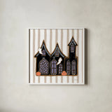Spooky Gingerbread Manor II by Yvette St. Amant. Shown in a crisp white glass frame for a clean and minimalist style. Available as an archival giclee rolled canvas, fine art paper, or poster print. SKU 101110a.