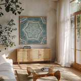 Star Mandala III by Yvette St. Amant. Shown in a natural wood frame in a cozy modern living room. Available as an archival giclee rolled canvas, fine art paper, or poster print. SKU 91311a.