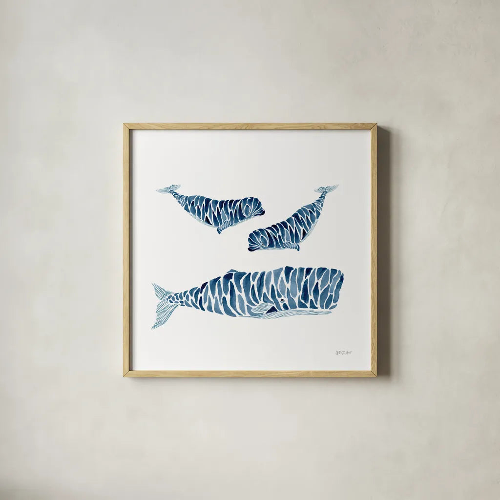 Three Whales by Yvette St. Amant. Shown in a natural wood glass frame for a timeless modern aesthetic. Available as an archival giclee rolled canvas, fine art paper, or poster print. SKU 90118a.