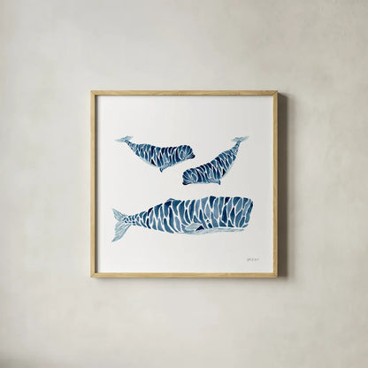 Three Whales by Yvette St. Amant. Shown in a natural wood glass frame for a timeless modern aesthetic. Available as an archival giclee rolled canvas, fine art paper, or poster print. SKU 90118a.
