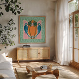 Tropical Birds III by Yvette St. Amant. Shown in a natural wood frame in a cozy modern living room. Available as an archival giclee rolled canvas, fine art paper, or poster print. SKU 98389a.